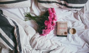 bouquet of pink flowers on top of bed