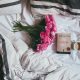 bouquet of pink flowers on top of bed