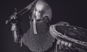 man with steel and chainmail armor holding sword