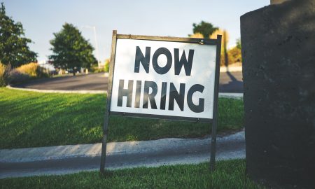 white and black now hiring signage