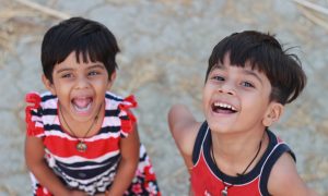 two toddlers standing outdoors