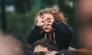 girl making hand gesture on her face