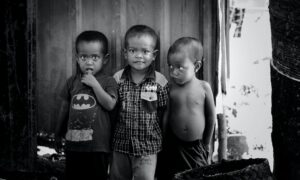 2 boys standing near wooden door