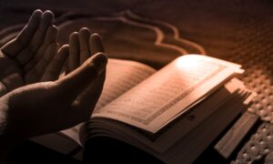 person reading book on brown textile