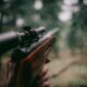 selective focus photography of brown hunting rifle