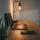 black laptop computer on brown wooden table