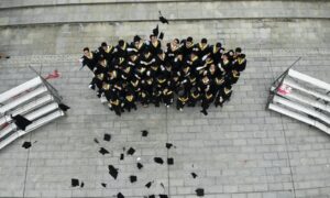 group of graduates throwing academic hats