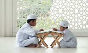 man in white thobe sitting on white floor tiles