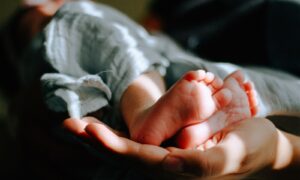 person holding baby feet