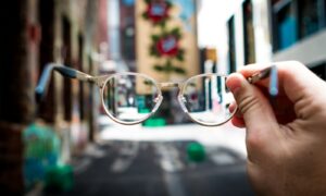 person holding eyeglasses