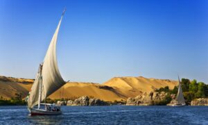 white sailboat on water under blue cloudy sky during daytime photo