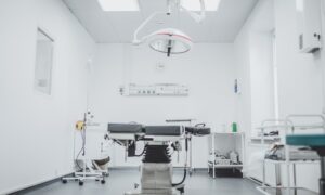 black and white hospital bed in the middle of interior building