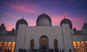 low-angle photography of a prayer temple under a purple sky