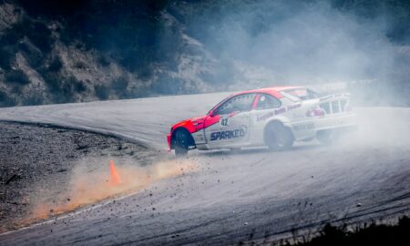 red and white stock car on road