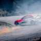 red and white stock car on road