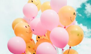 low-angle photo of pink and orange balloons