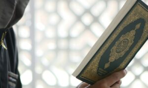 a close up of a person holding a book