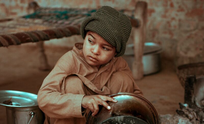 boy holding stock pot