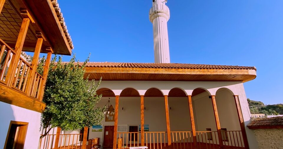 a building with a clock tower in the background